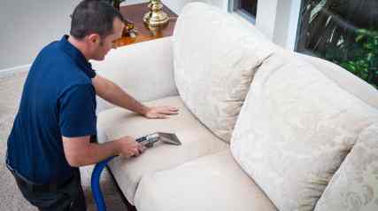 man cleaning upholstery