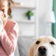 child with allergies blowing her nose