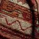 oriental rug with a pipe resting on it.